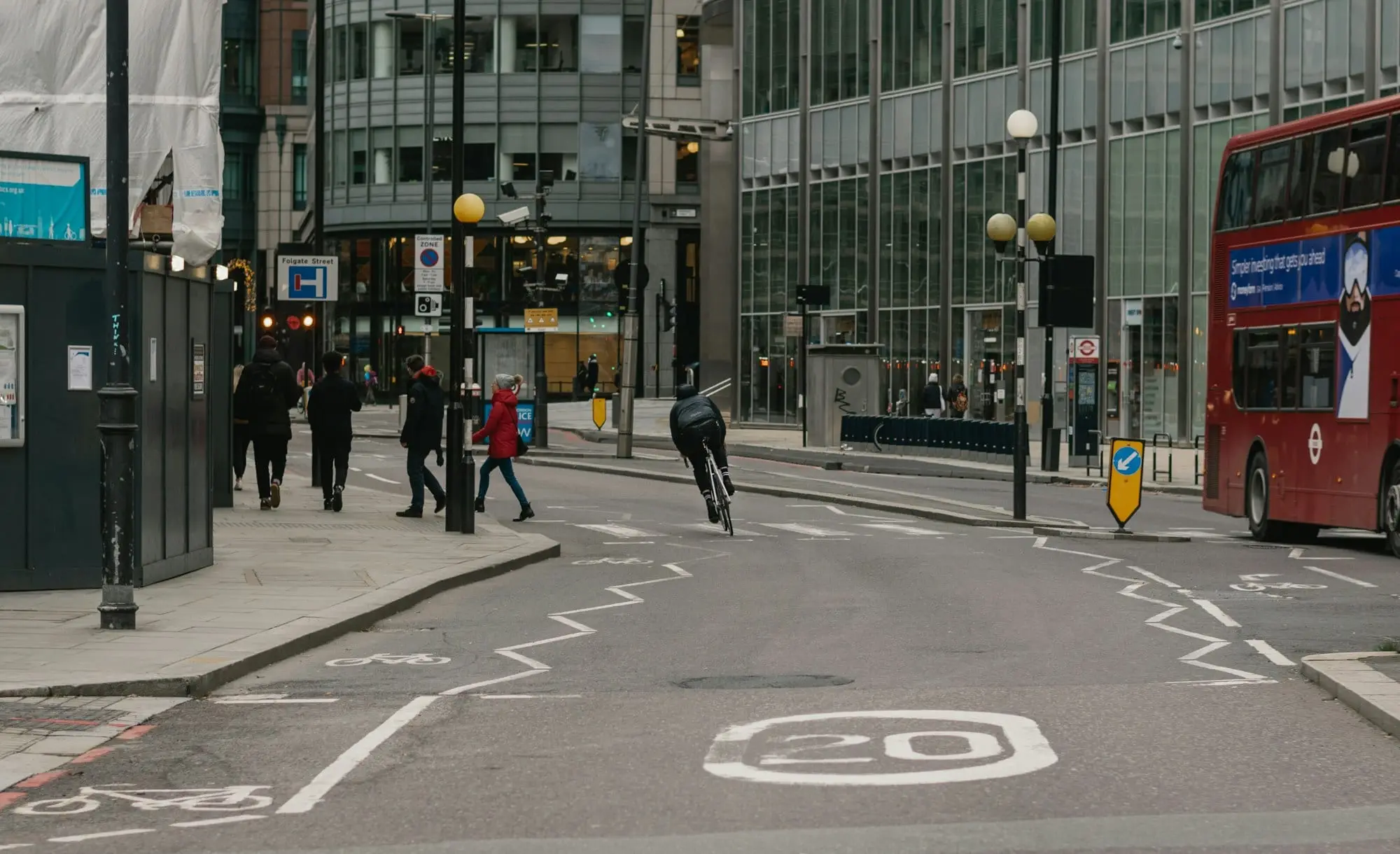 A London street with office buildings and a red double-decker bus