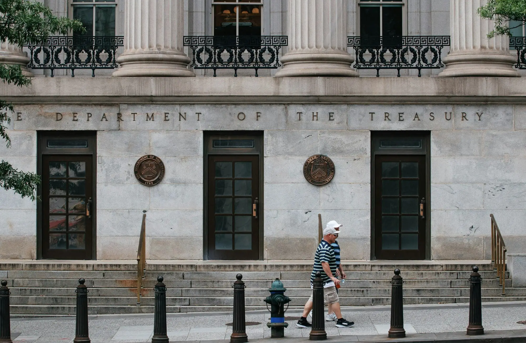 Entrance of the US Department of the Treasury building in Washington, with its name carved above the doors